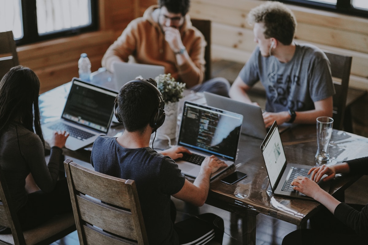 Team members collaborating at a shared desk.