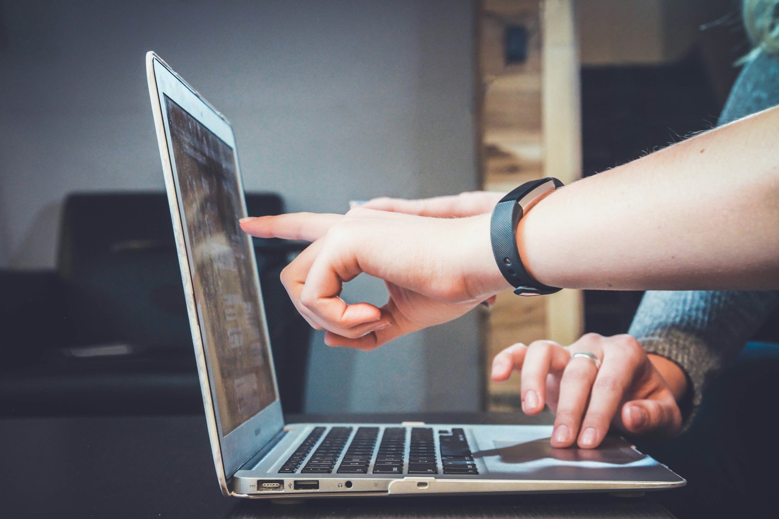 Person using a laptop in a home workspace—illustrating everyday reliance on connectivity.